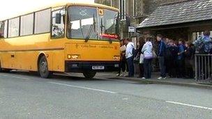 Pupils waiting for a school bus in Wales