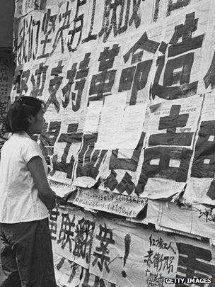 A Chinese girl reading propaganda posters in Guangzhou, 1966