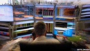 trader in front of screen