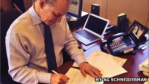 NY AG Schneiderman signing papers