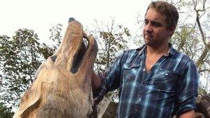 Ben Loughrill and his wolf sculpture