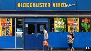 People walk past Blockbusters store (file photo 2010)