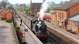 Steam train going through West Somerset Railway line.