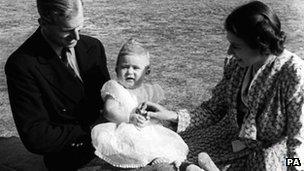 A baby Prince Charles with his parent in 1949