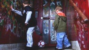 Boys play football in doorway