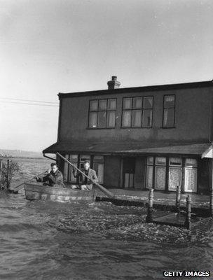 Residents using a rowing boat to leave their homes in 1953 (Getty Images)