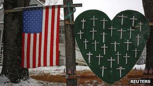 A memorial honouring the victims killed in the Sandy Hook Elementary School shooting is seen outside a home in Sandy Hook, Connecticut, on 10 December 2013