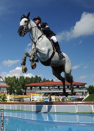 Ben Maher jumps over a water hazard on Cella during a Masters event in Calgary in September