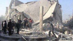 Syrians inspect a damaged building