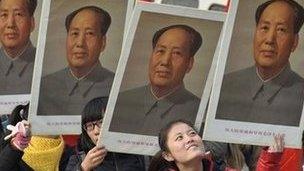 Students hold portraits of China's late Chairman Mao Zedong during a commemorative event ahead of December 26, which marks the 120th anniversary of Mao's birth, at a university campus in Taiyuan, Shanxi province, December 21, 2013.