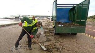 Workmen clearing debris