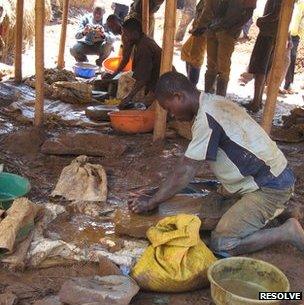 Gold-laden pebbles, fresh from the Chien Mechant Mine, are crushed into silt in preparation for gold panning in the Lubona Village, Democratic Republic of Congo