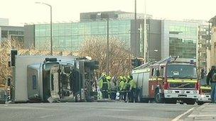 Lorry on its side and fire engine