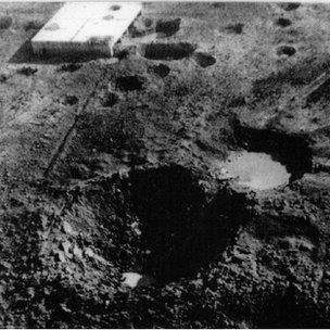 The crater on Ashley Walk created by the Grand Slam in the New Forest on 13 March 1945 - with the target building in the background