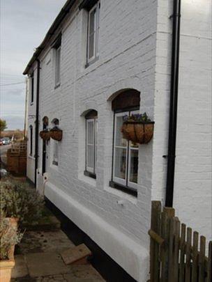 Front of house with pipe leading out from living room