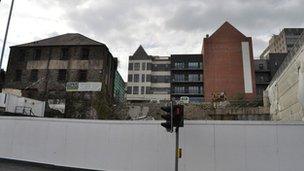 The warehouse seen from the road below