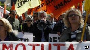 A protester chants anti-austerity slogans through a loud hailer during a rally in the northern Greek port city of Thessaloniki on 09/04/14