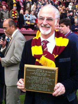 Prof David Sharpe is acknowledged at half-time on the pitch during Bradford's League One match against Crawley Town.