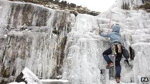 An ice climber at a frozen waterfall in the Brecon Beacons