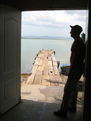 A fisherman looks out to sea in Guantanamo Bay, Cuba in June 2014