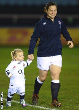 England hooker Emma Croker walks onto the field with daughter Lucy ahead of this year's Six Nations match with Wales