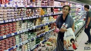 A woman holds dairy products in a supermarket in Moscow