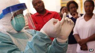 A health worker in protective clothing