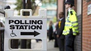 A police officer stands outside a polling station in Tower Hamlets