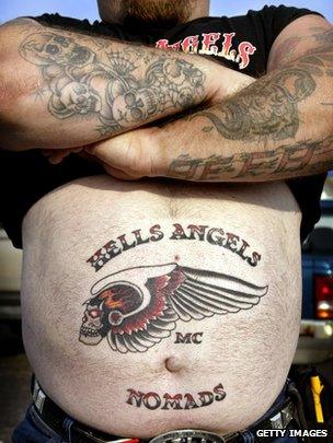 Nomad Dave shows off the new Hells Angels tattoo on his stomach as he attends a Hells Angels rally July 26, 2003 in Peru, Illinois