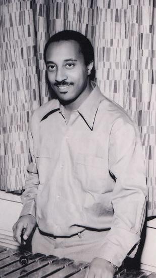 Mulatu Astatke as a young man standing at the vibraphone.