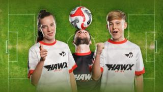 Three footballer posing in front of a football field