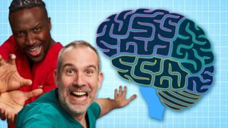 Two doctors wearing doctors scrubs are standing next to a drawing of a brain