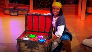 Gem sitting next to a chest full of jewels