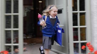 young student excitedly running to school