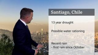 Matt Taylor stands in front of a chart with information about the drought in Chile.