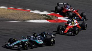 Mercedes' George Russell comes out of a hairpin ahead of Ferrari's Lewis Hamilton with Charles Leclerc immediately behind during the Chinese Grand Prix sprint race