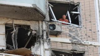 A man inspects a damaged apartment building following a Ukrainian drone attack in the Moscow region, Russia. Photo: 17 May 2026