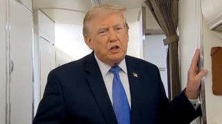 Trump stands in doorway inside Air Force One