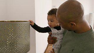 A dad and his son looking at a lampshade