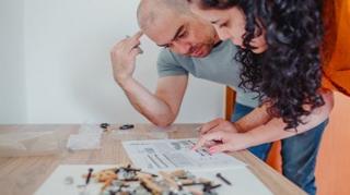 A picture of a man and a woman reading instructions.