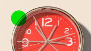 A red clock showing grey whirring hands, on the upper left there is a red logo which reads BBC InDepth in white lettering