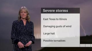 Louise Lear stands in front of a list of weather features brought by US storms