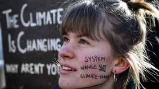 Woman with slogan painted on her face