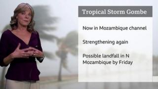 Louise Lear standing in front of a graphic with details of Tropical Cyclone Gombe