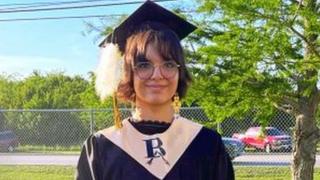 A photo of Lena Black wearing her sacred eagle plume on her graduation cap