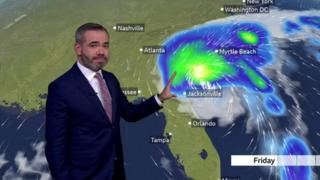 Ben Rich standing in front of a US weather map