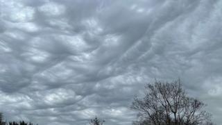 Wave-like asperitas clouds in the sky creating a grey sky tinged with white