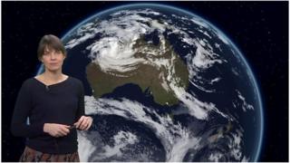 Sue Powell in front of satellite image