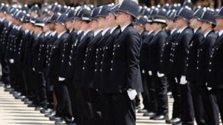 Newly qualified Metropolitan police officers take part in their passing out parade at Hendon Police Training College on June 29, 2012