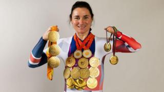 Dame Sarah Storey posing with her gold medals